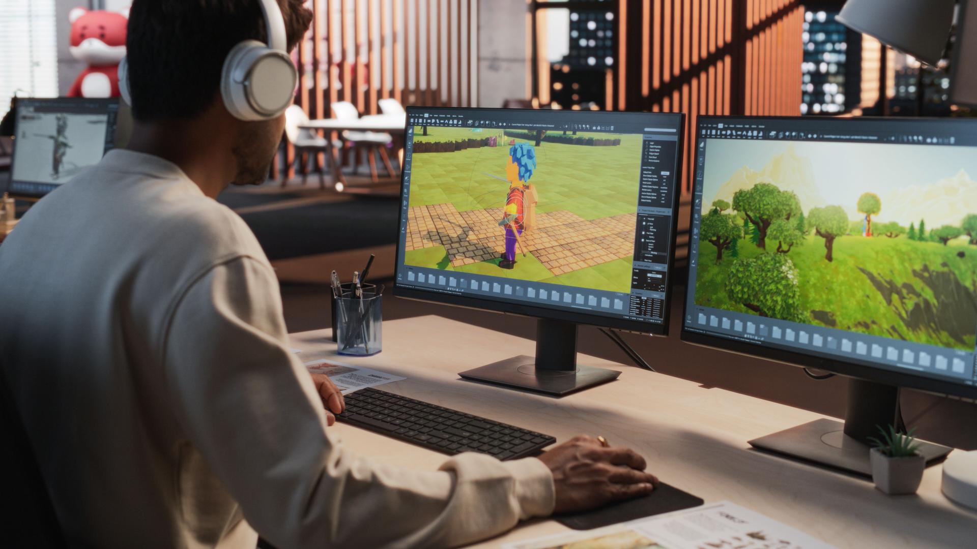 Indian Male Game Designer Using Desktop Computer With 3D modelling Software To Design Characters And World For Immersive Adventure Video Game. Man Working In Game Development Company Diverse Office.